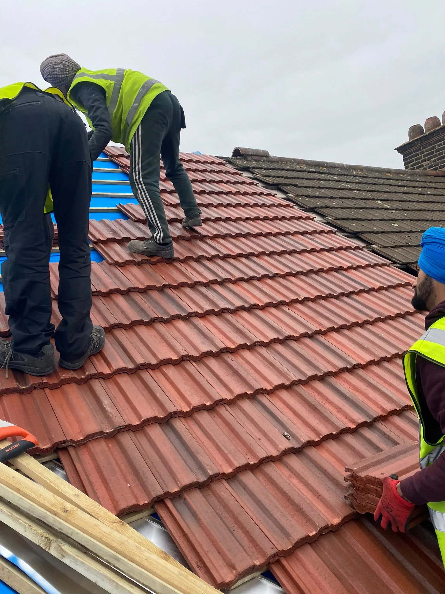 Newly installed dark tiled pitched roof